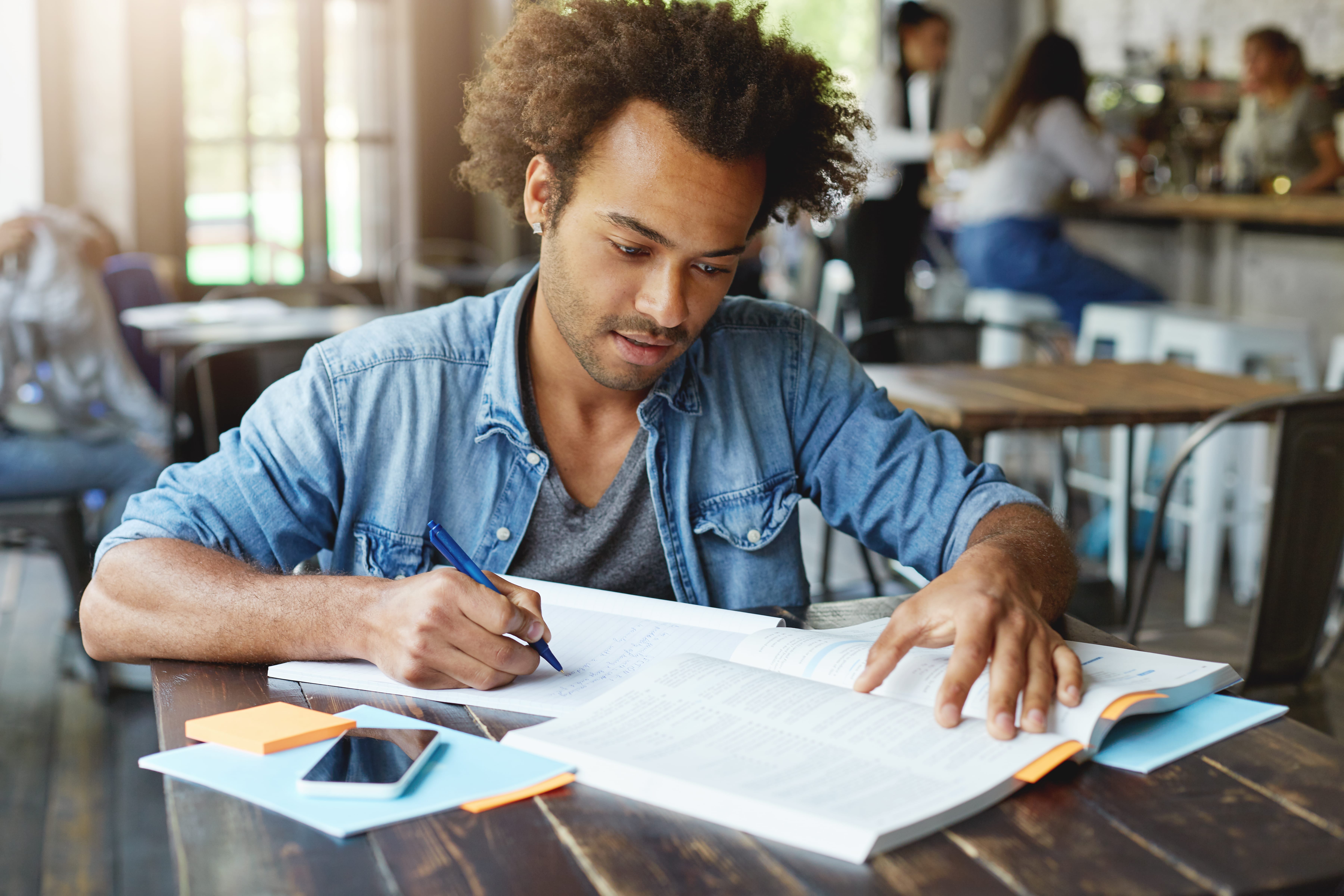 handsome-stylish-afro-american-university-student-studying-at-cafe